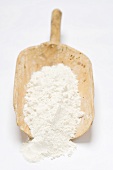 Flour in old wooden scoop