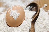 Egg in flour with wooden spoon