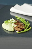 Beef with avocado cream and green asparagus