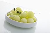 Honeydew Melon Balls in Dish with Thyme Sprig
