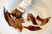 Brush with chocolate in a dish