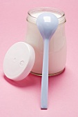 Jar of yoghurt with plastic spoon