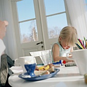 Blond girl at breakfast table