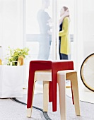 Two stools, man and woman in background