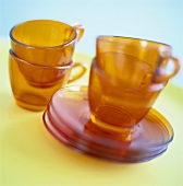Yellow glass cups and saucers