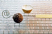 A chocolate truffle on a metal rack