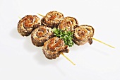 Slices of roulade stuffed with minced pork on skewers