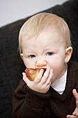 Baby eating an apple
