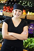 Supermarket employee in vegetable section of supermarket (Sweden)