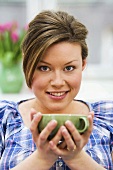 Woman holding cup of tea