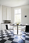 Kitchen with black & white floor tiles & furniture (Sweden)
