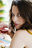Young woman holding glass of wine