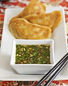 Dim sum (deep-fried pork and prawn dumplings with spicy coriander sauce, China)