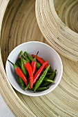 Green and red chillies in a dish