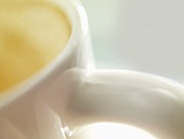 A cup of milky coffee (close-up)