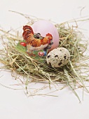 Easter egg and quail's egg in Easter nest