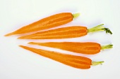 Four slices of carrot with tops