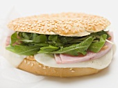 Ham, cheese and rocket in sesame bagel