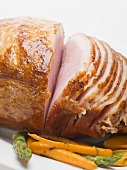 Glazed roast ham with carrots and asparagus