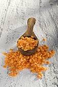 Red lentils on wooden spoon