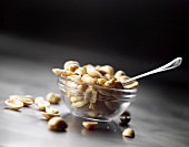Peanuts in glass dish with spoon