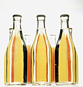 Several bottles of syrup in rows