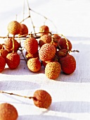 Lychees on white fabric