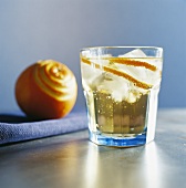 Drink with orange peel and ice cubes