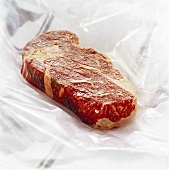 Raw entrecôte steak on polythene