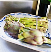 Asparagus and artichokes on serving platter