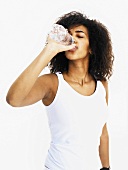 Woman drinking water out of bottle