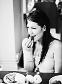 Young woman eating strawberries