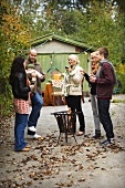 Family drinking wine in an autumn garden