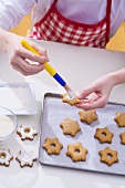 Girl decorating Christmas biscuits