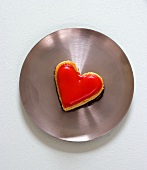 Heart-shaped petit four on metal plate