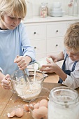 Two boys baking (adding milk)