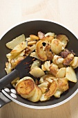Fried potatoes in frying pan