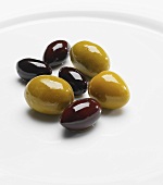 Black and green olives on white plate