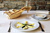 Home-made ravioli, Parmesan, bread basket and glass of wine