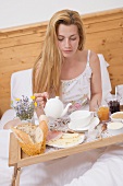 Woman having breakfast in bed