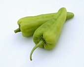 Two Green Peppers on a White Background