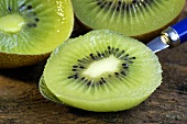 Kiwi fruit, one half on a spoon