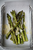 Roasted green asparagus with Parmesan in aluminium dish