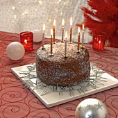 Christmas cake with burning candles