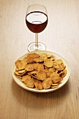 Dish of spelt crackers and a glass of red wine