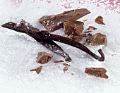 Baking ingredients (vanilla pods, pieces of chocolate and sugar)