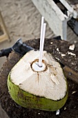 Green coconut with straw