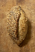 A loaf of wholemeal bread on wooden background