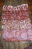 Various types of salami on a wooden board