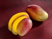 A whole mango and a sliced mango